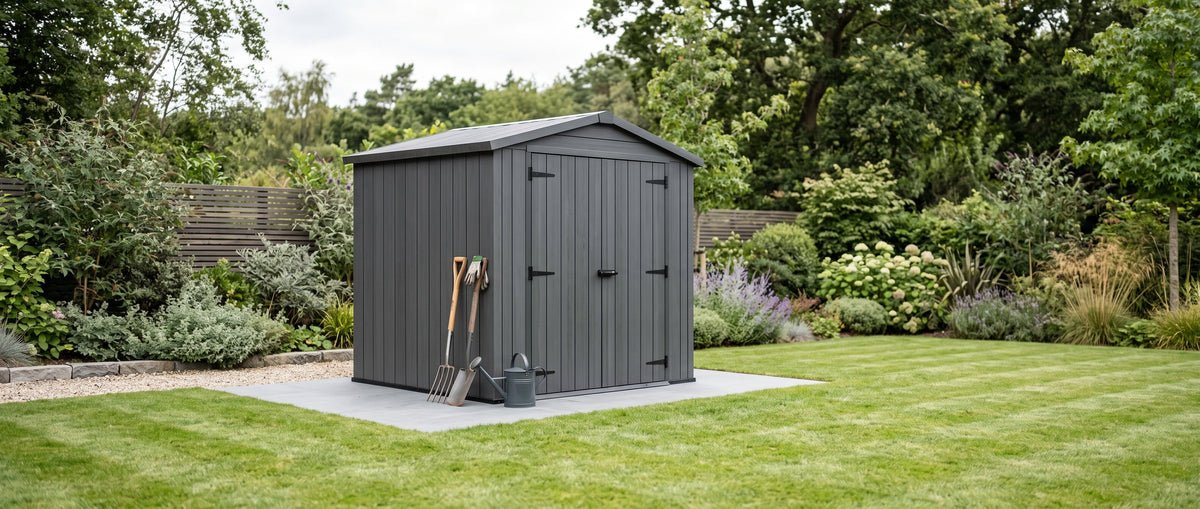 Dark grey garden storage shed on a lawn, part of Bambelou's Garden & Outdoor collection